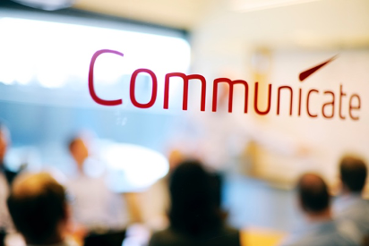 A screen with the word "communicate" in red font