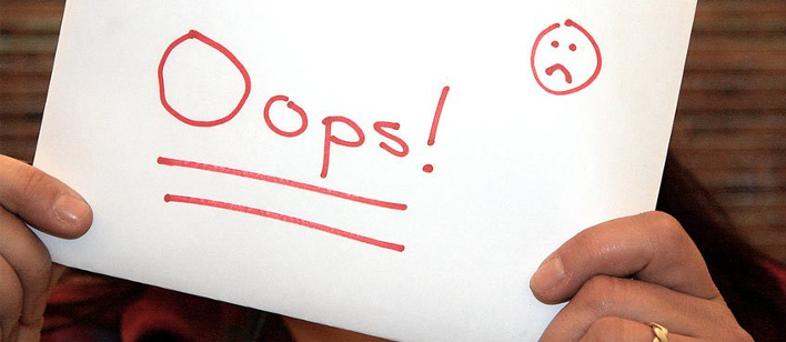 man holding a paper with the word oops in it
paper with a sad face